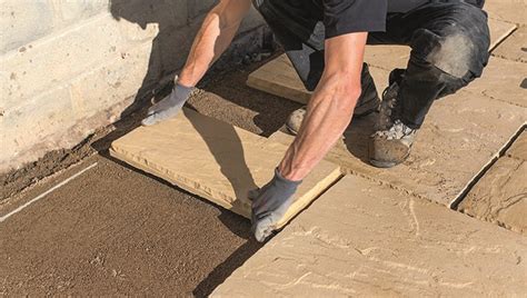 Can I use building sand for laying slabs?