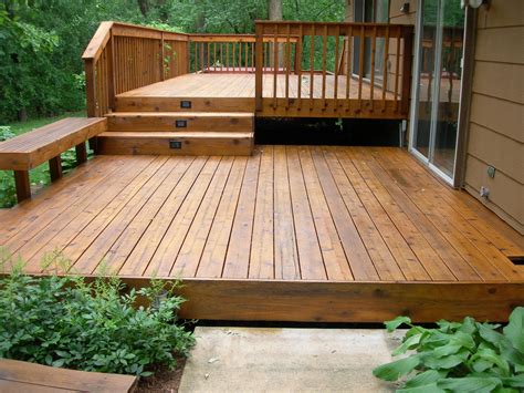 Can wood deck touch the ground?