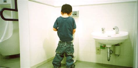 Do boys learn to pee standing up?