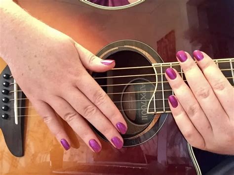 Do long nails affect guitar playing?