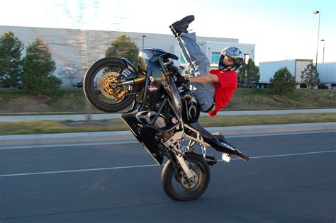 Do motorcycles go faster when doing a wheelie?