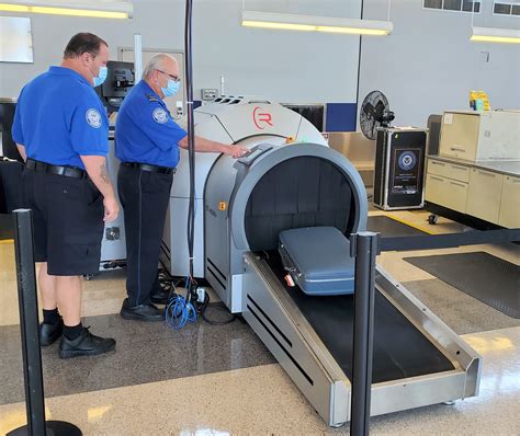 How are checked bags screened?