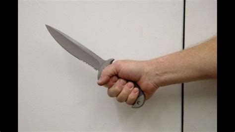 How are you supposed to hold a knife in self-defense?