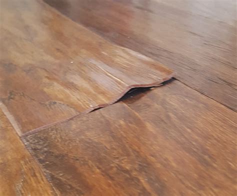 How can you tell if a hardwood floor is water damaged?