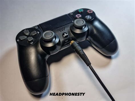 How do I connect my headphones to my PS4 controller?