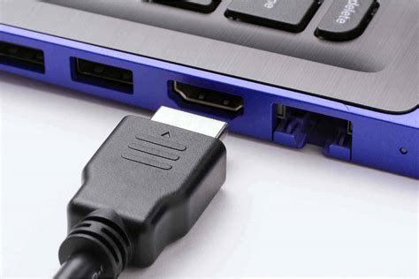 How do I enable HDMI output on my laptop?