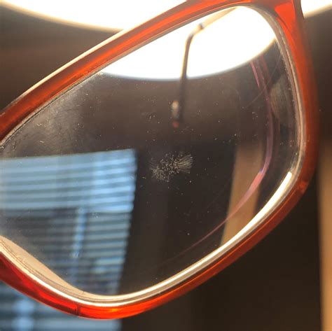 How do I know if my glasses lens coating is damaged?