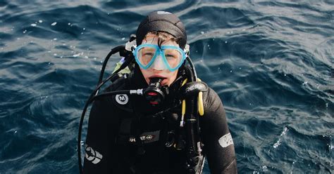 How do divers stay underwater without floating up?