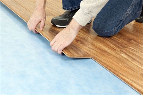 How do you apply underlayment to vinyl flooring?