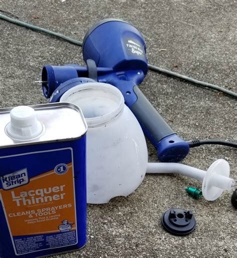 How do you clean a spray gun after oil based paint?