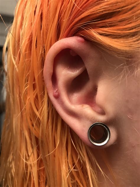 How do you clean dried blood around piercings?