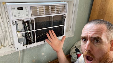 How do you clean the outside coils on a window air conditioner?