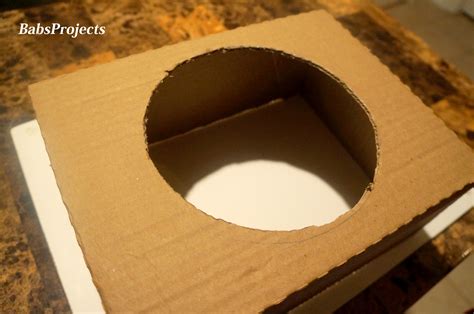 How do you cut a hole in cardboard?