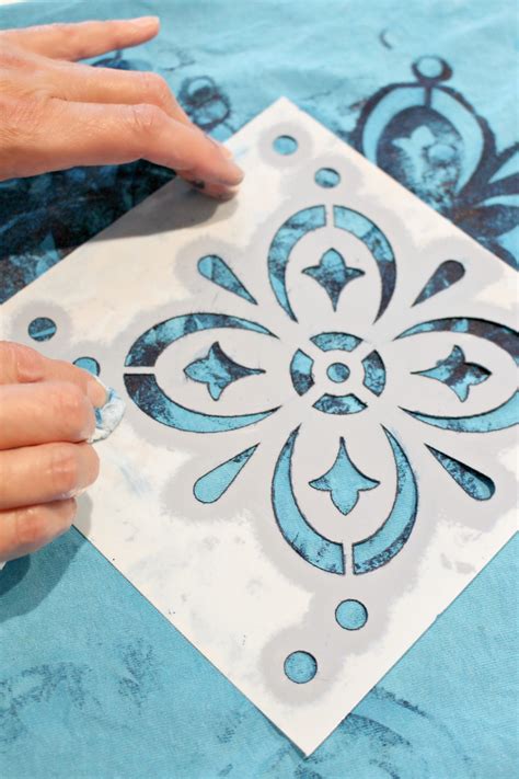 How do you get stencils to stick to fabric?