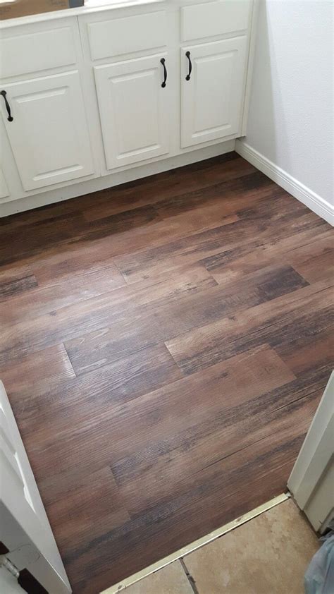 How do you get vinyl to stick to wood floors?