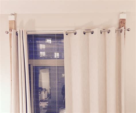 How do you hang curtains without screwing into the wall?