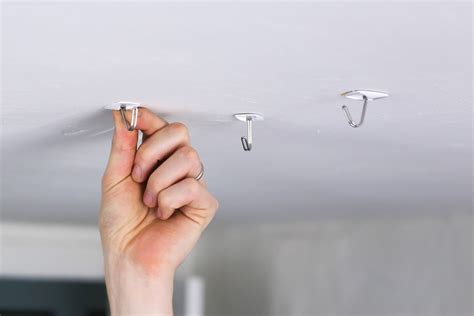 How do you hang something heavy from the ceiling without drilling?