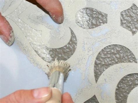 How do you hold a stencil in place?