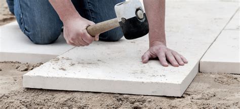 How do you lay paving slabs on soil?