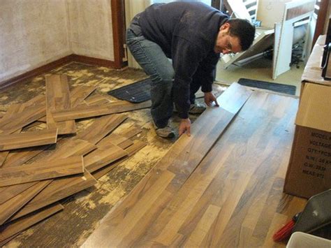 How do you lift glued laminate flooring?