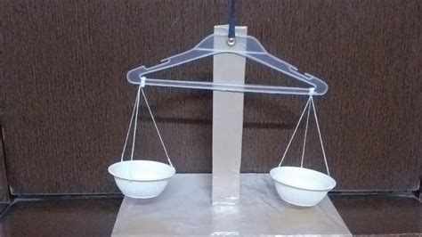 How do you make a balance scale with a hanger?