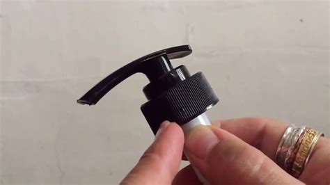 How do you open a pump bottle nozzle?
