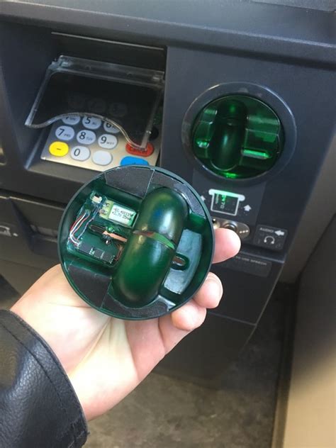 How do you tell if there is a skimmer on an ATM?