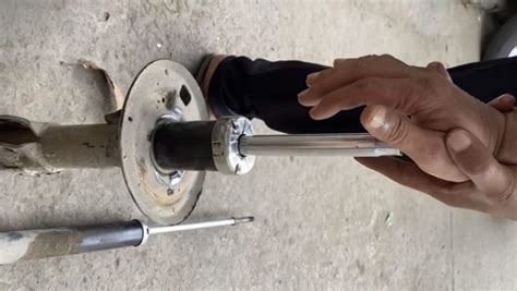 How do you test shock absorbers by hand?