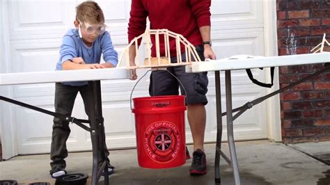 How do you test the strength of a popsicle stick bridge?