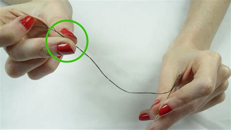 How do you tie a thread to a needle?