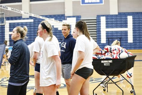 How many coaches can stand in volleyball?