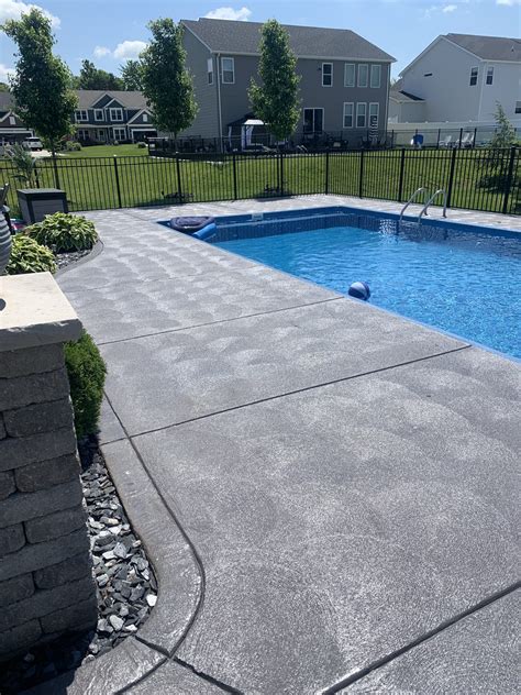How thick should a concrete slab be around a pool?
