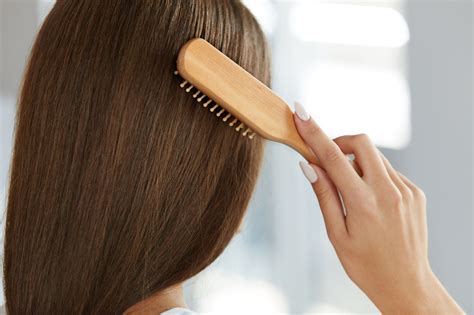 Is it OK to brush hair with hand?