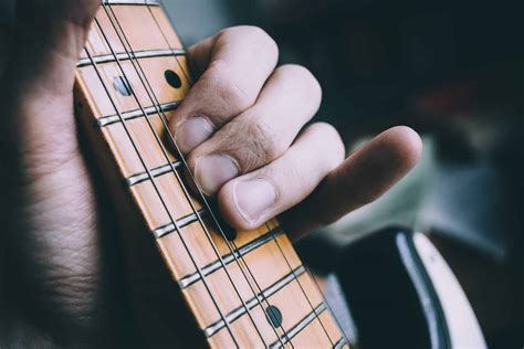 Is it OK to play guitar with fingers?