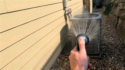 Is it OK to spray AC unit with water?