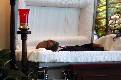 Is it OK to touch a person in a casket?