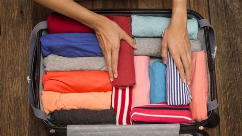 Is it better to roll or fold clothes in a suitcase?