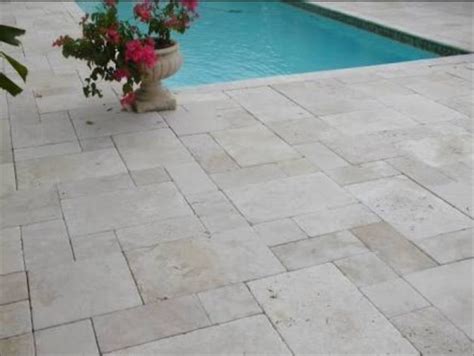 Is natural stone more expensive than pavers?