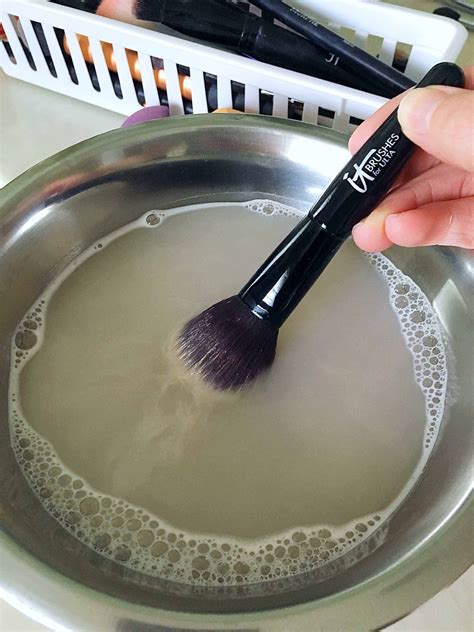 Should I use hot or cold water to clean makeup brushes?
