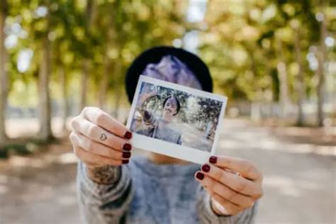 Should Polaroids develop in light or dark?