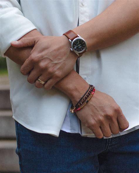 Should men wear bracelets with a watch?