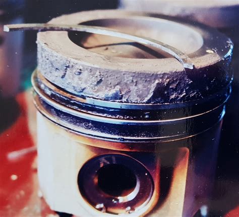 What can I use to free a stuck piston ring?