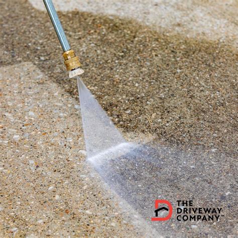 What do you spray your driveway with before pressure washing?