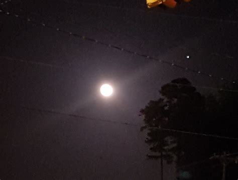 What is the bright star next to the moon?