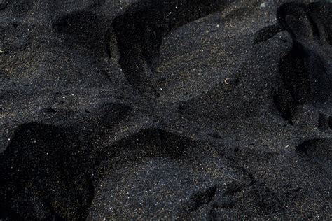 What makes sand black?