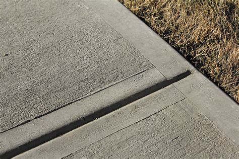 When should expansion joints be cut in concrete?