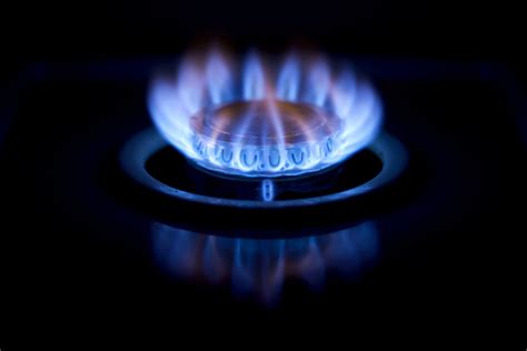 Which gas burns with blue flame?