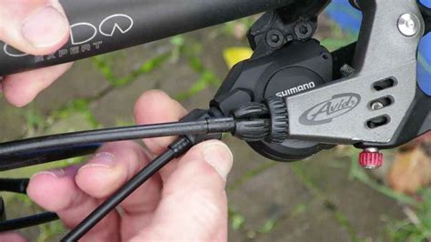 Which way do you turn the barrel adjuster on a front derailleur?