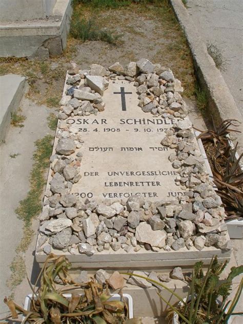 Who is standing at the grave at the end of Schindler's List?