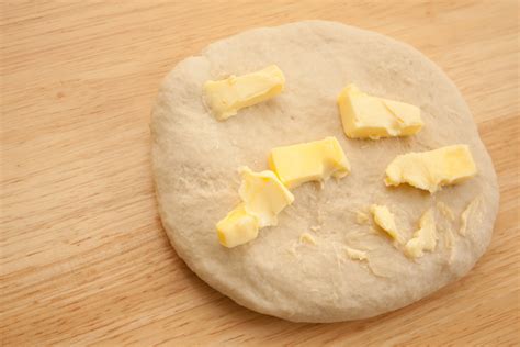 Why add butter after dough is mixed?